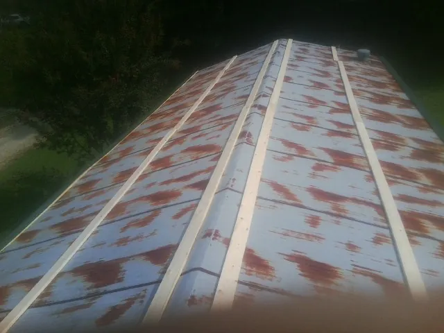 Rusted metal roof panels with new wood purlins before replacement — Storm Damage Roof Repair in Naugatuck by Roofing Brothers