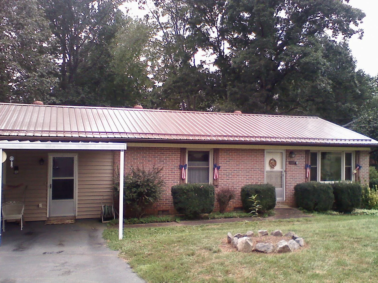 Bronze metal roof and carport on a brick ranch home — Roof Repair work by our crew in Naugatuck